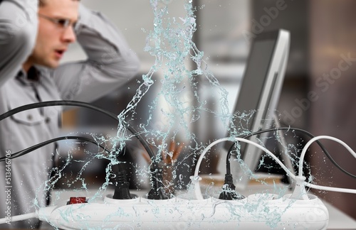 Quadro em tela A bank of plugs on a desk with water leaks falling next to a man working in dang