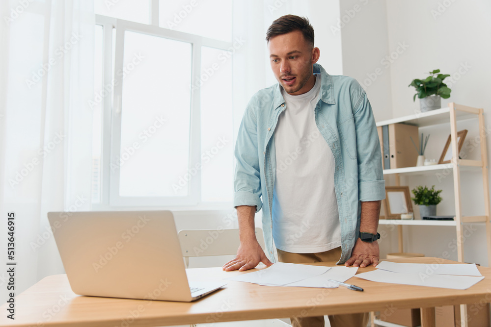 Thoughtful pensive handsome stylish young businessman deals with documents and papers for work project reclines on office table. Copy space for ad. Remote Job, Technology And Career Profession Concept