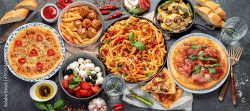 Italian food assortment on dark background.