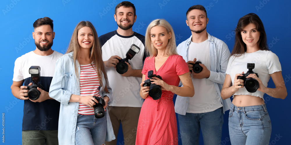 Obraz premium Group of young photographers on blue background