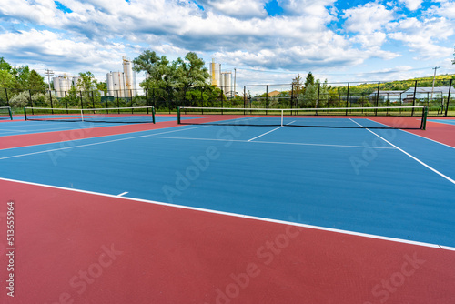 New blue tennis courts with white lines and red out of play area.  © Thomas