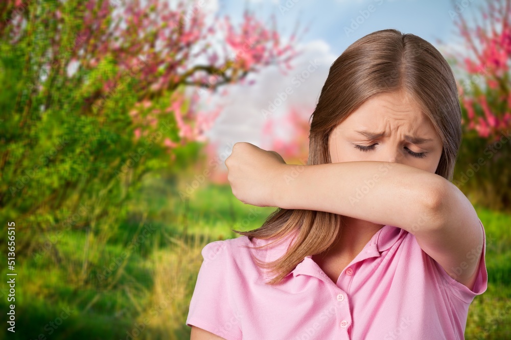Woman allergic suffering from seasonal allergy at spring garden. Spring allergy concept Woman allergic suffering from seasonal allergy at spring garden. Spring allergy concept