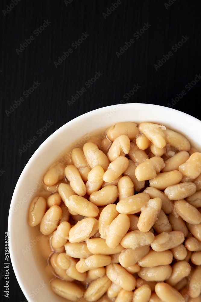 Organic White Cannellini Beans in a White Bowl, top view. Flat lay, overhead, from above. Copy space. Organic White Cannellini Beans in a White Bowl, top view. Flat lay, overhead, from above. Copy space.