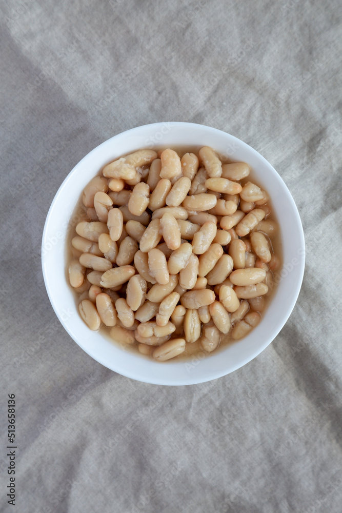 Organic White Cannellini Beans in a White Bowl, top view. Flat lay, overhead, from above.
