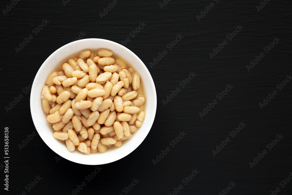 Organic White Cannellini Beans in a White Bowl, top view. Flat lay, overhead, from above. Copy space. Organic White Cannellini Beans in a White Bowl, top view. Flat lay, overhead, from above. Copy space.