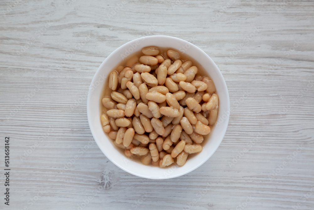 Organic White Cannellini Beans in a White Bowl, top view. Flat lay, overhead, from above. Organic White Cannellini Beans in a White Bowl, top view. Flat lay, overhead, from above.