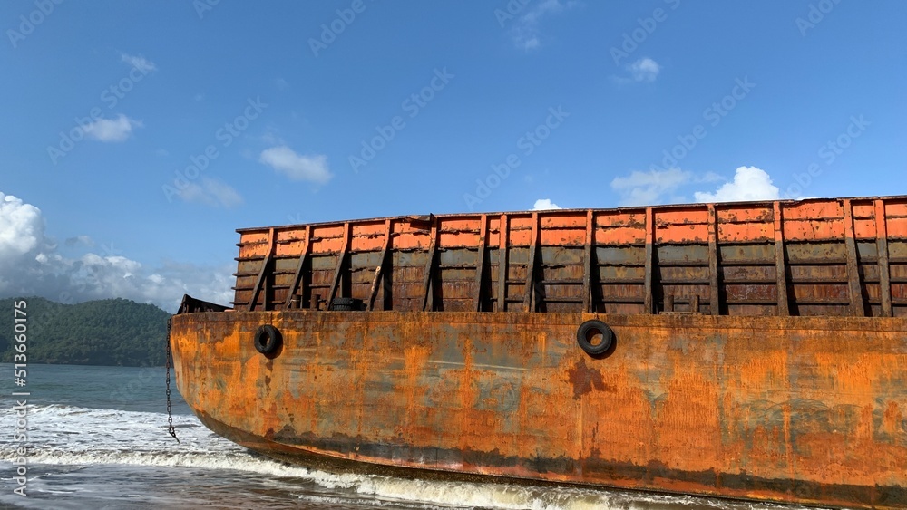 Pancer Door Beach, Pacitan, Indonesia - June 28, 2002: Tongkang Gold Trans 317 barge transporting coal from Cilacap to Kalimantan docked at Pacitan Bay, due to bad weather in the middle of the ocean