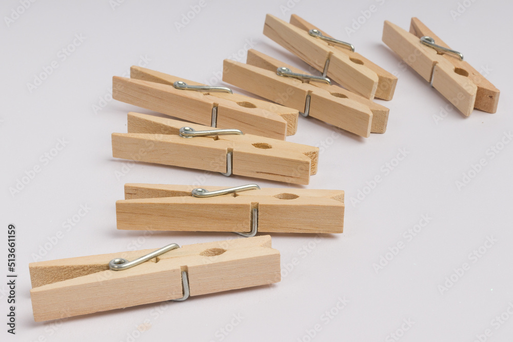 wooden clothespins lie in a corner on a white background with copy space wooden clothespins lie in a corner on a white background with copy space