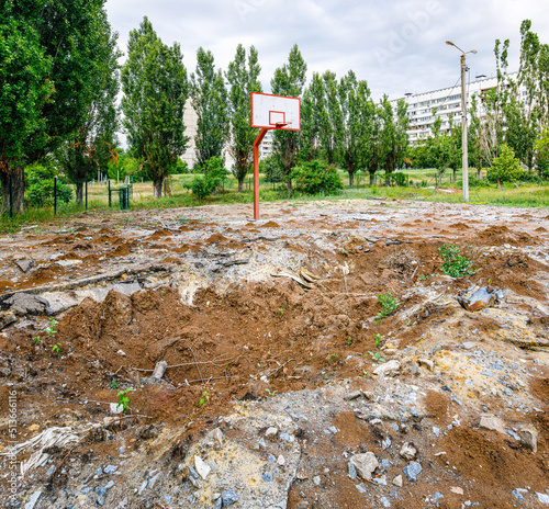basketball court destroyed by a Russian air bomb on the territory of the school. Funnel from the 