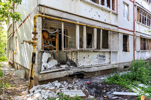 Destroyed and burned apartments in a multi-storey residential building. Residential area Saltovka. War in Ukraine. photo