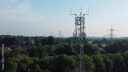 5G broadcasting tower antenna in British countryside landscape background slow aerial dolly right view,