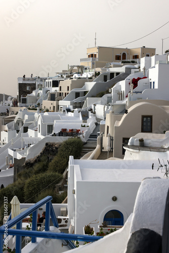 Whitewashed houses with terraces and pools and a beautiful view in Imerovigli on Santorini island, Greece © wjarek