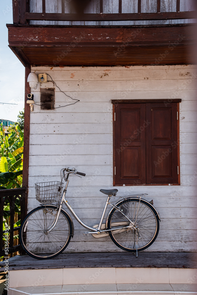 retro bicycle in front of old wooden house.