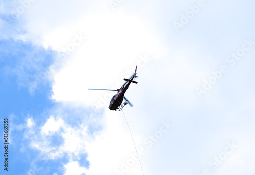 Fototapeta Naklejka Na Ścianę i Meble -  A picture with motion blur of fast moving helicopter used for logistics and transportation.