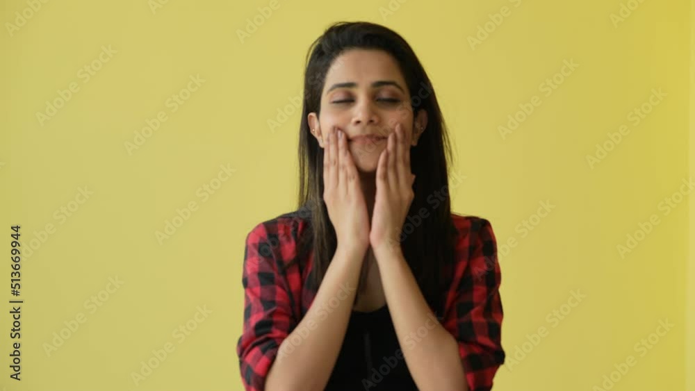 A young Indian woman looking gorgeous and smiling,stroke the cheek.she looks likes pretty. A young Indian woman looking gorgeous and smiling,stroke the cheek.she looks likes pretty.