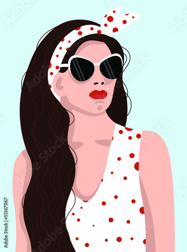 A girl with flowing hair in sunglasses and a polka-dot top.