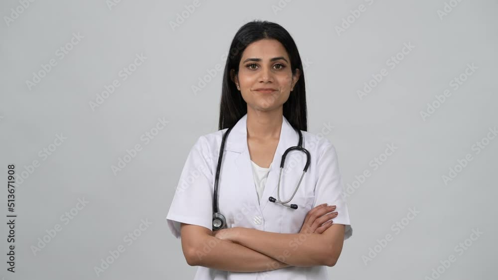 Happy young Indian woman doctor wearing white medical coat and ...