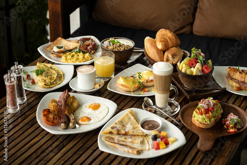 many mixed western breakfast food items on cafe table