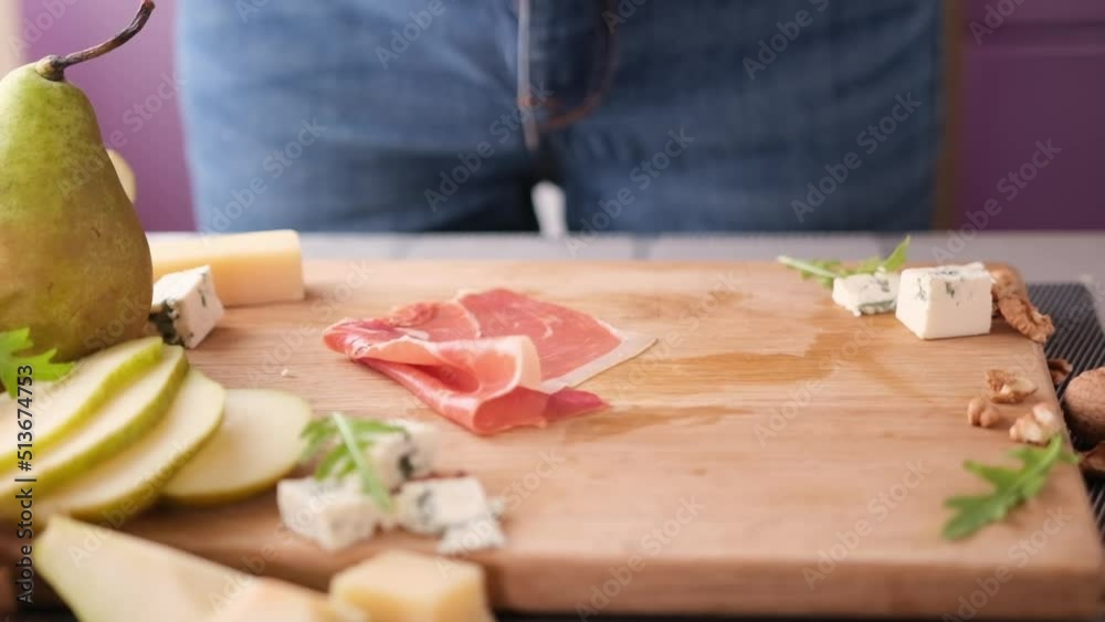 Making pear and blue cheese salad - slices of jamon Making pear and blue cheese salad - slices of jamon