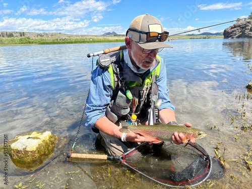 catch of a beautiful rainbow trout by a fly fisherman in Montana