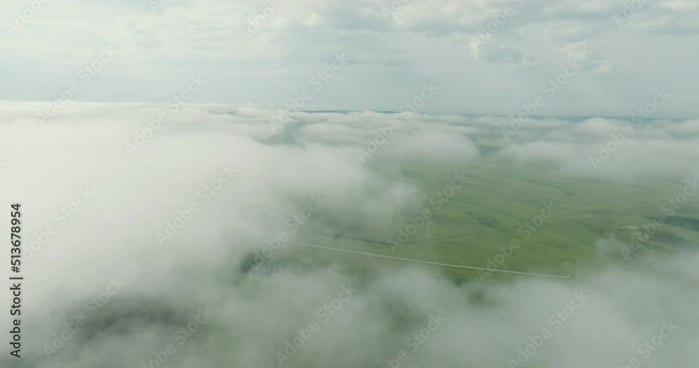 Flying over the fog and blue sky over the top of the inversion cloud level on a bright sunny day. Aerial photography from drone, aerial photography Flying over the fog and blue sky over the top of the inversion cloud level on a bright sunny day. Aerial photography from drone, aerial photography
