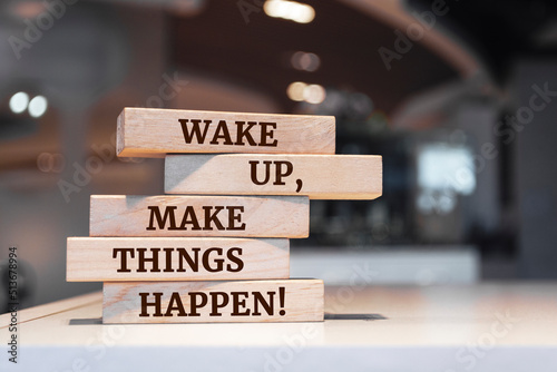 Wooden blocks with words 'Wake up, make things happen!'.