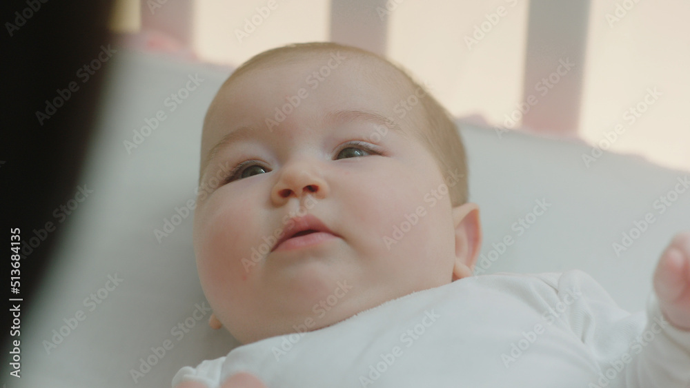 In front of the camera charismatic young mother have a morning routine with her baby she kissing carefully the legs of her baby In front of the camera charismatic young mother have a morning routine with her baby she kissing carefully the legs of her baby