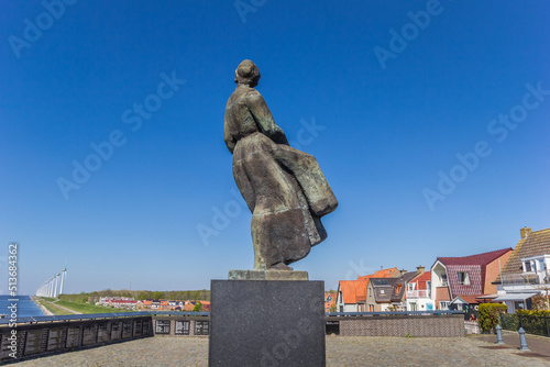 Statue of a woman looking back to the sea in Urk, Netherlands photo