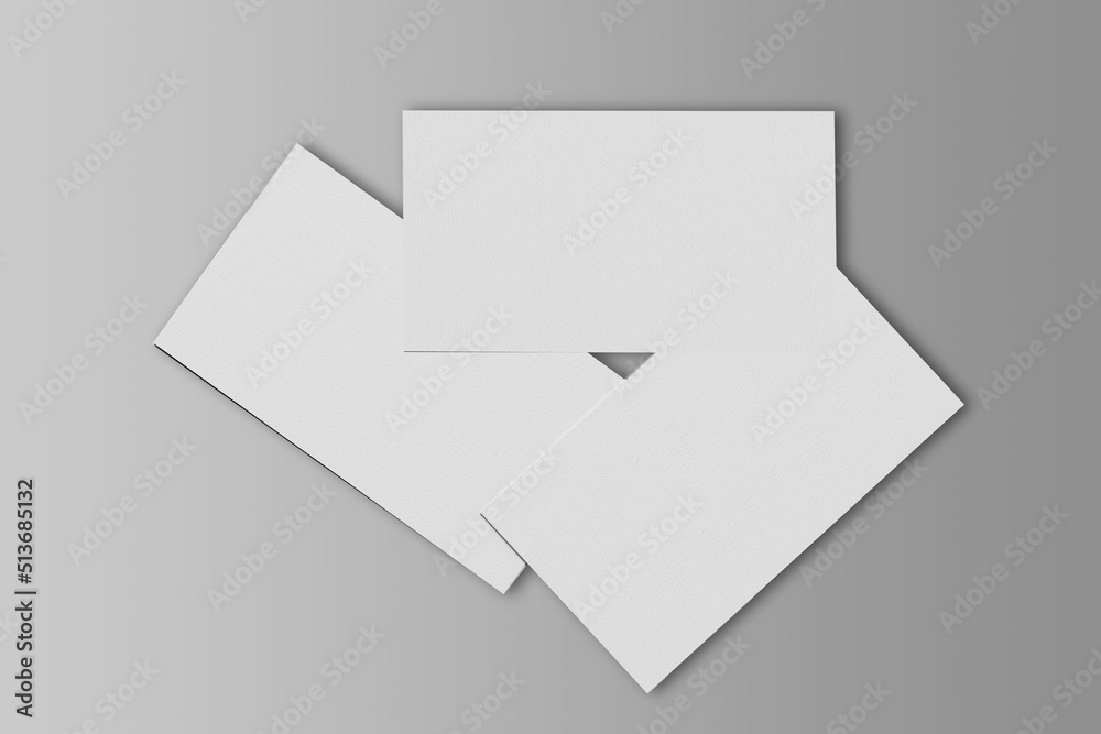 Three scattered business cards mockup isolated on a grey background. 3d rendering. Three scattered business cards mockup isolated on a grey background. 3d rendering.