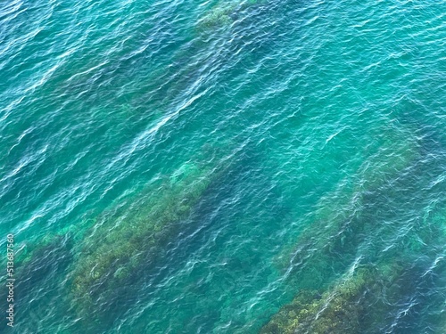 Sea blue turquoise water waves on the beach aerial view. Beautiful seascape. © OLENA