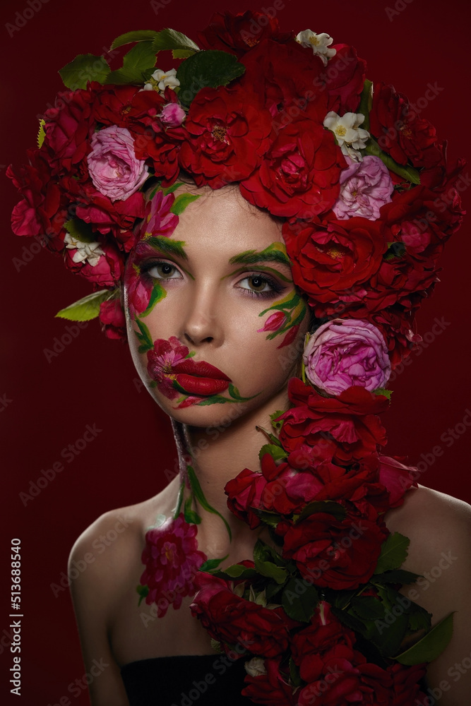 Portrait of a beautiful girl with exquisite makeup and a wreath of red tea roses Portrait of a beautiful girl with exquisite makeup and a wreath of red tea roses