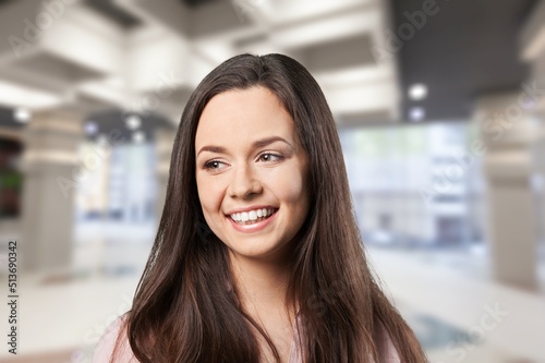Beautiful young female standing in shop background.
