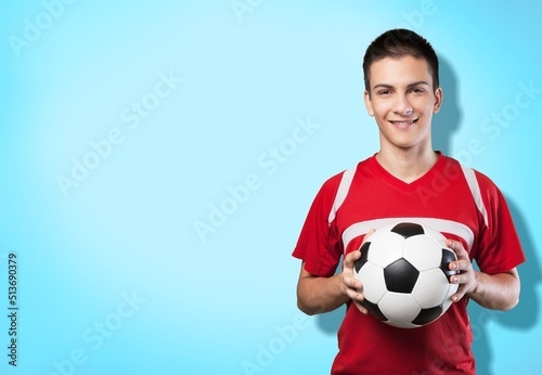 Happy young man with football in red t-shirt. Soccer ball celebrate. © BillionPhotos.com