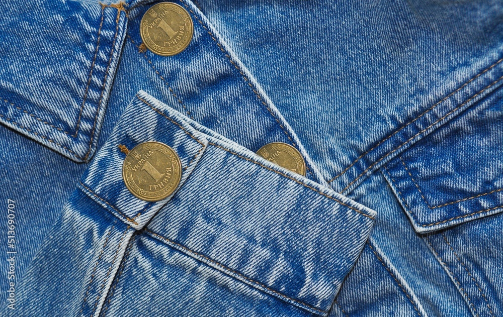 Part of Jeans jacket with gold coin cuffings and buttons .denomination one hryvnia.translation from Ukrainian :Ukraine, 1 hryvnia. Part of Jeans jacket with gold coin cuffings and buttons .denomination one hryvnia.translation from Ukrainian :Ukraine, 1 hryvnia.