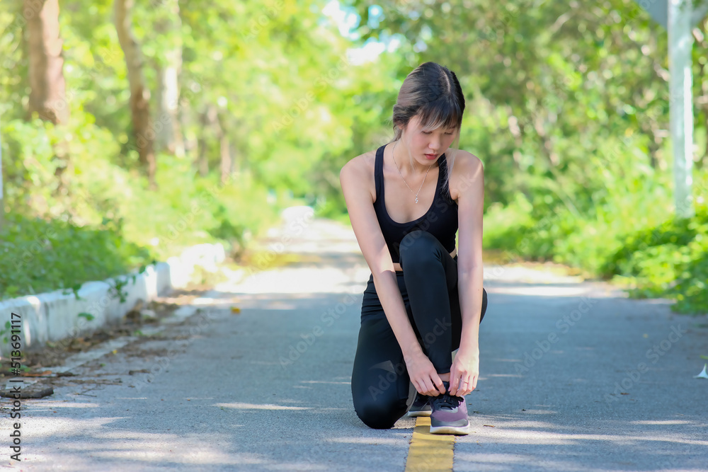 woman exercising outside by herself. getting in shape for a marathon. jogger on a nature trail working on their cardio fitness woman exercising outside by herself. getting in shape for a marathon. jogger on a nature trail working on their cardio fitness