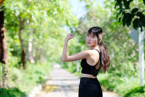 Sporty young woman stretching her arms while exercising outdoors. Shot of a fit young woman stretching before a run outdoors. Healthy lifestyle.