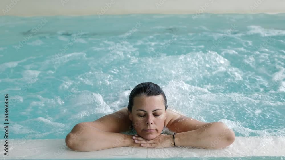 Woman with Eyes Closed Relax in a Hydromassage Pool with Bubbles in Switzerland. Woman with Eyes Closed Relax in a Hydromassage Pool with Bubbles in Switzerland.