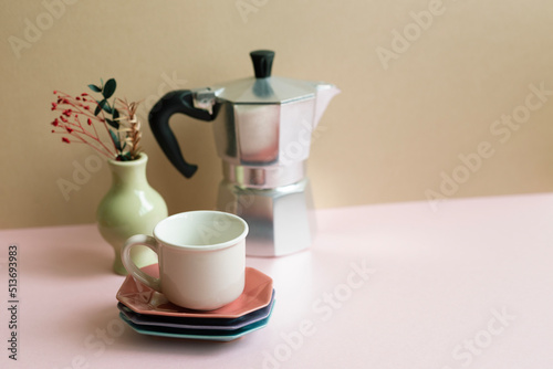 Obraz na płótnie Mocha coffee pot, cup, dry flowers on pink table. beige wall background w salonie