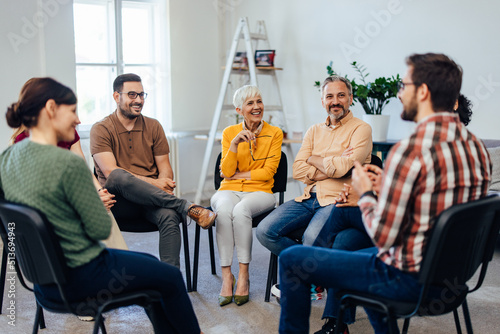 All aged people, sitting in a circle, having a group therapy about mental health.