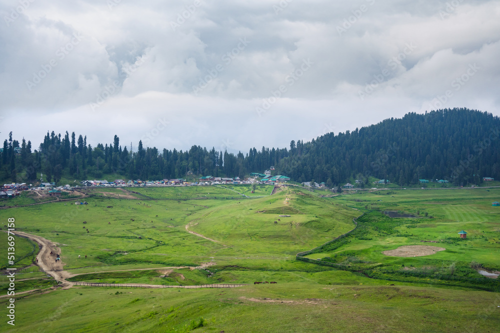 Gulmarg, known as Gulmarag in Kashmiri, is a town, hill station, popular skiing destination, and notified area committee in the Baramulla district of Jammu and Kashmir, India.