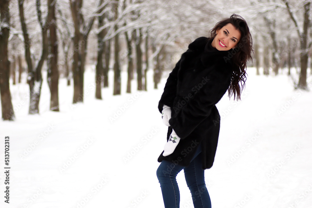 A young couple walk in a winter park A young couple walk in a winter park