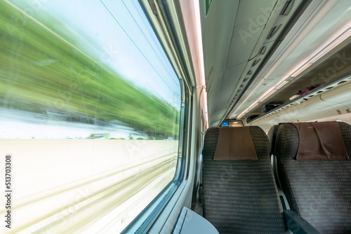 View of a Window scrolling the Landscape inside High Speed Train
