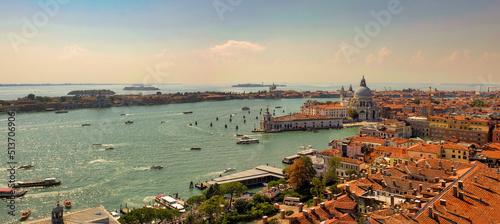 Aerial panorama view of Basilica of Santa Maria della Salute against dramatic sky during day time, located at Punta della Dogana between the Grand Canal and the Giudecca Canal, in Venice, Italy