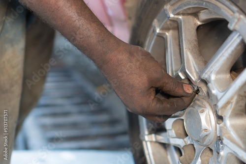hands of a mechanic close up repairing a car
