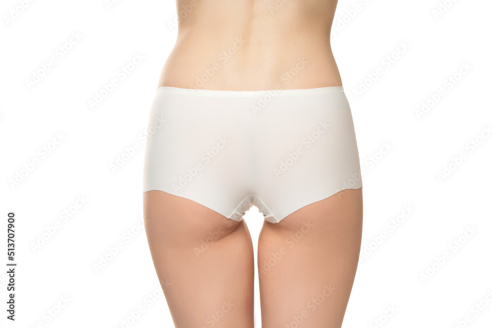 Mid section of woman wearing white briefs, back view on a white