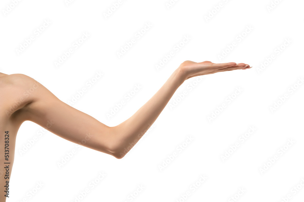 Young woman's stretched skinny arm and open palm holding imaginary product. Isolated on white background Young woman's stretched skinny arm and open palm holding imaginary product. Isolated on white background