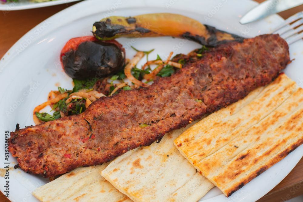 turkish adana kebab served with bread and salad