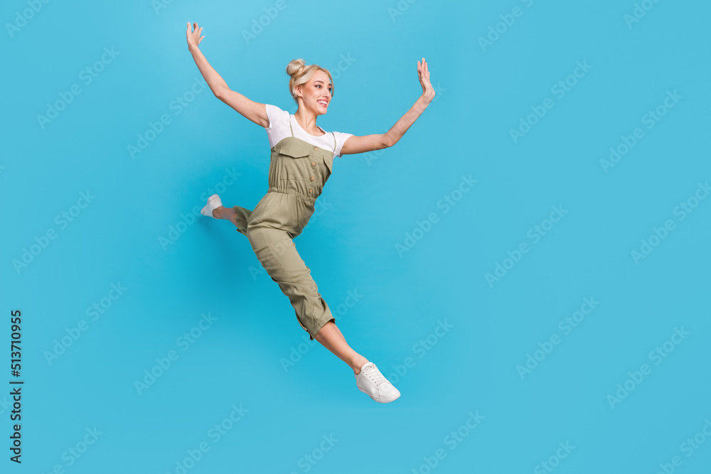 Full size photo of cool millennial lady jump wear t-shirt grey overall shoes isolated on blue background