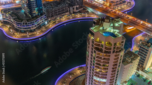 Dubai Marina waterfront and city promenade night timelapse from above.