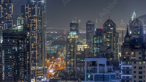 Dubai Marina and Media City districts with modern skyscrapers and office buildings aerial night timelapse.